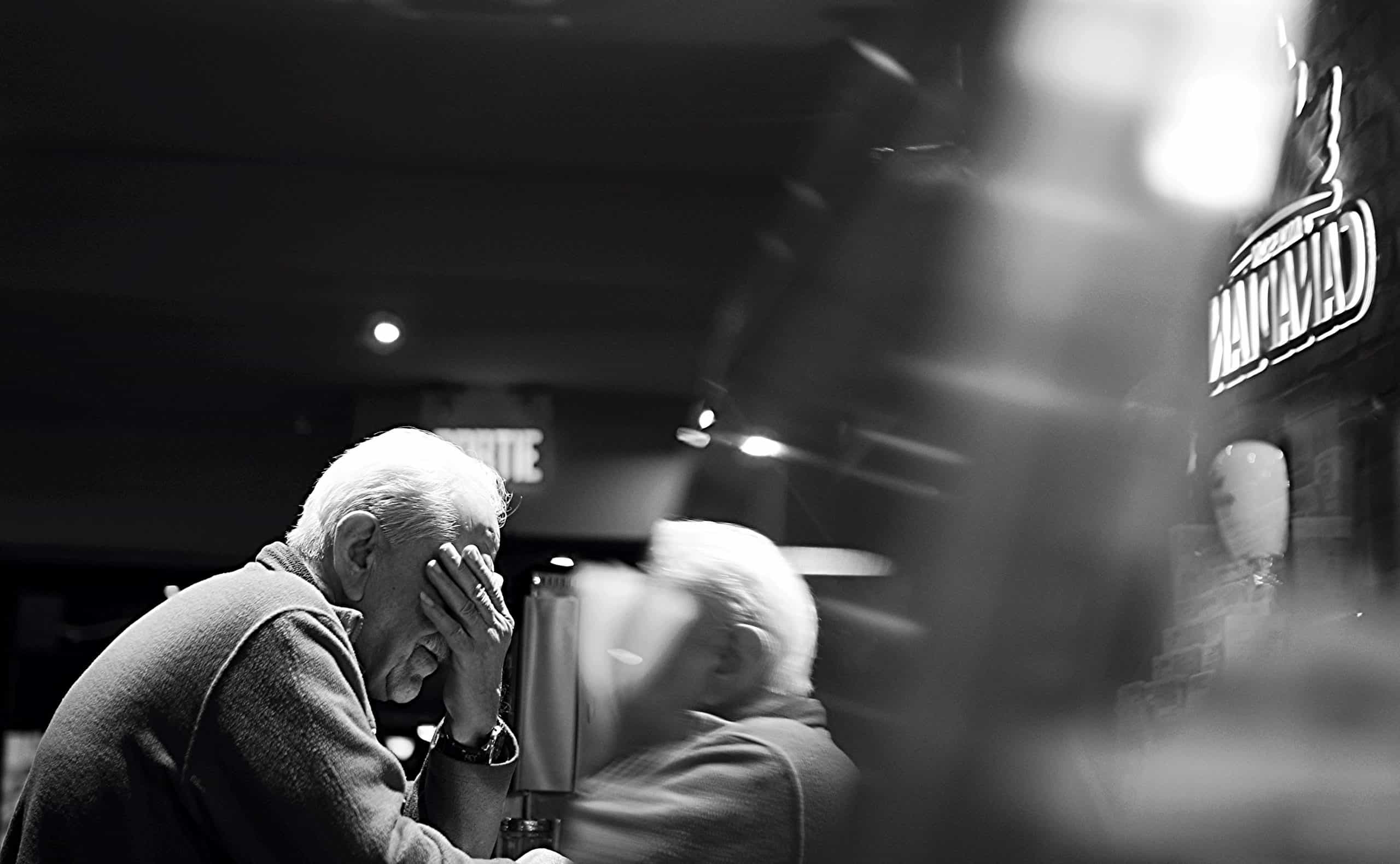 Older Man Covering His Face
