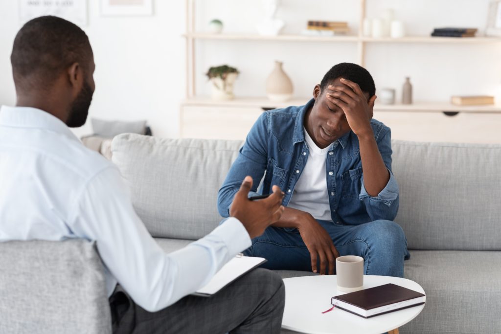 Understanding Dry Drunk Syndrome 4 young man in therapy to talk about his alcoholism