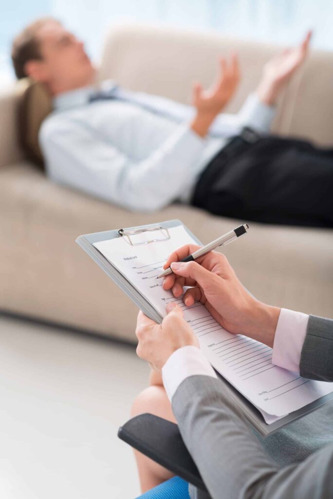 Dual Diagnosis Treatment Centers in Nashville, TN 1 doctor writing while patient describes issues on couch